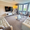 Photo 8: Large lounge with TV and sofas