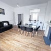Photo 4: Large Living room - High ceilings with full height windows with oblique sea views