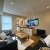 Photo 1: Lounge/Kitchen- 65 inch TV