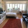 Photo 2: This is the living room! (mind we’re currently renovating and getting rid of the bed!)