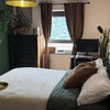 Photo 1: Furnished double room with desk, monitor, TV on wall, blackout curtains & large chest of drawers 