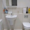Photo 6: Bath with shower, sink and toilet. Mirrored bathroom cabinet