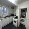 Photo 8: Washroom and tumble dryer in kitchen