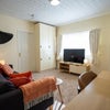 Photo 6: A spacious lounge linking the bedroom and kitchen areas