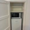 Photo 4: Microwave and fridge in addition to shared kitchen.