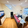 Photo 4: Spacious living area / Sofa / Chair / TV / Undercounters for storage 