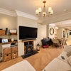 Photo 4: Living Room with large sofa and TV