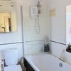 Photo 9: Small but functional bathroom with both a bath & (electric) shower