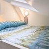 Photo 2: King -size mezanine bed under vaulted ceiling with skylight