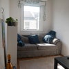 Photo 9: Living room is small but has a sofa and a TV