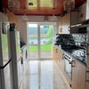 Photo 4: Communal Kitchen with tumble dryer, washing machine, dishwasher and two fridge-freezers