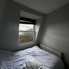 Photo 5: Room 2 — bed and window