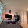 Photo 5: Includes big TV in the room with WFH standing desk and chair setup and big wardrobe