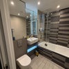 Photo 4: Private bathroom with bath and shower.