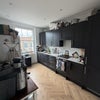 Photo 2: Shared kitchen with washer and dryer.