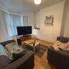 Photo 7: Living room with 2 sofas, coffee table, and huge tv 
