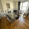 Photo 2: Large Living room - High ceilings with full height windows with oblique sea views