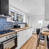 Photo 3: Modern fully equipped shared kitchen with integrated appliances and dining space