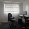 Photo 2: Bedroom 1, currently used as study (included: desk, chair, bookshelf, carpet, single mattress)