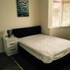 Photo 8: room showing bed and part of bay window