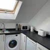 Photo 5: Kitchenette with washing machine and fridge/freezer