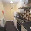 Photo 4: Galley kitchen shared between 2