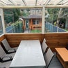 Photo 6: Morning coffee has found its spot—covered dining overlooking the garden.