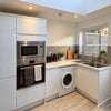 Photo 5: Oven, built in microwave and washing machine