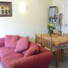 Photo 5: Living room with sofas, cable TV, dining table.
