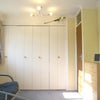 Photo 2: The room contains a double bed, large futon, desk, shelving. It has 2 windows, curtains & en-suite