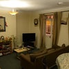Photo 2: Lounge with 2 sofas, TV, coffee table and dining table