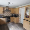 Photo 5: A large kitchen with a gas hob and oven, extractor hood and plenty of storage space.