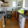 Photo 6: Kitchen with washer dryer