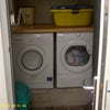 Photo 2: separate laundry room with washing machine and tumble dryer