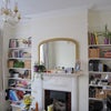 Photo 2: Sitting room with shelves and fireplace