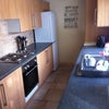 Photo 3: Kitchen with dedicated fridge and cupboard space for every room