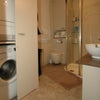 Photo 7: downstairs bathroom with double shower, washing and drying machine, sink and floating loo