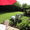 Photo 9: Garden with patio furniture and sun loungers 