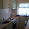 Photo 5: Galley kitchen with oven, hob, microwave