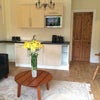 Photo 2: sitting room showing kitchenette and door to bedroom