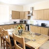 Photo 2: Kitchen with oak table, 2 fridge/ freezers, microwave & crockery