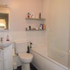Photo 2: Main bathroom with bath and shower, loo and basin with plenty of storage.