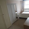 Photo 3: The bedroom with double bed and plenty of storage.
