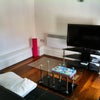 Photo 2: Living room with TV
