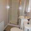 Photo 4: En-suit bathroom with shower, basin and loo.