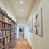 Photo 2: Large hallway with room for shelving/storage.