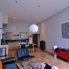 Photo 3: Living room/kitchen. Some furniture may be going, so there is room for more.