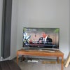Photo 6: 49" Samsung Curved TV wall mounted. Black upright radiator.