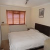 Photo 4: Bedroom 1 (includes Large triple wardobe and chest of drawers)