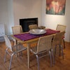 Photo 2: Dining area and woodstove